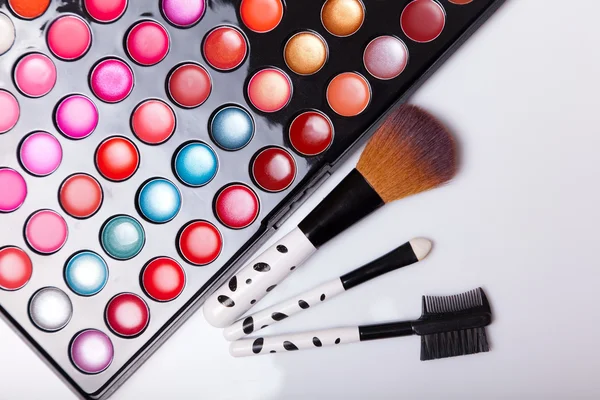 Colorful lip gloss palette with set of brushes — Stock Photo, Image