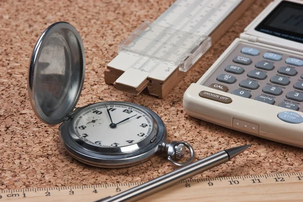 Pocket watch, calculator and slide rule