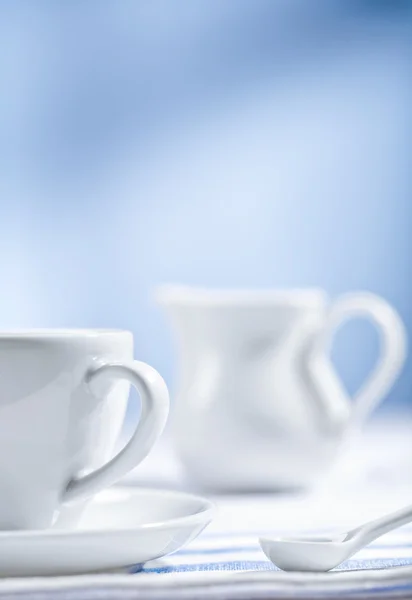 Stock image White cup and spoon with jug