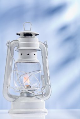 Kerosene lamp on blue background clipart