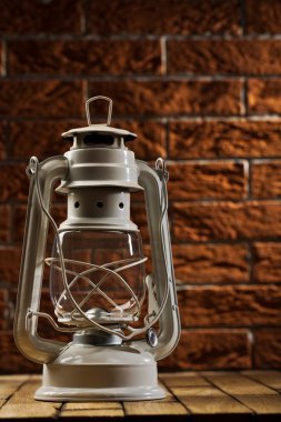 White kerosene lamp on background of the brickwall clipart