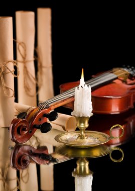Old violin witn candle ond old scroll of paper clipart