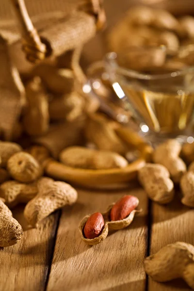 Peanuts with sack and oil — Stock Photo, Image