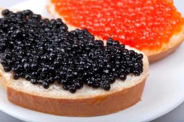Two sandwichs with red and black caviar on plate — Stock Photo, Image