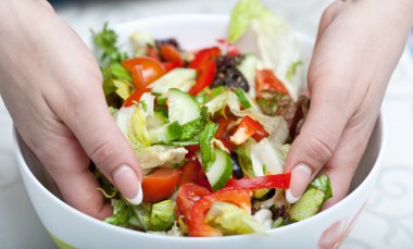 Woman hands mixes salad clipart