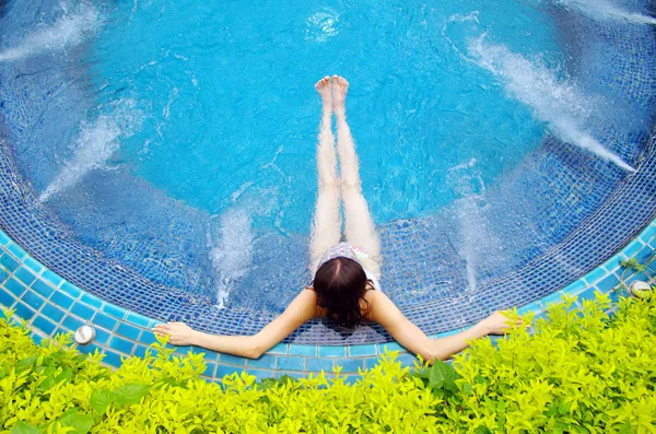 Mujer sentada en la piscina — Foto de Stock