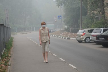 Woman Walking in Thick Smog clipart