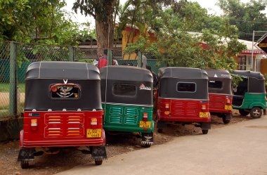 Three-wheelers at the Cabstand clipart