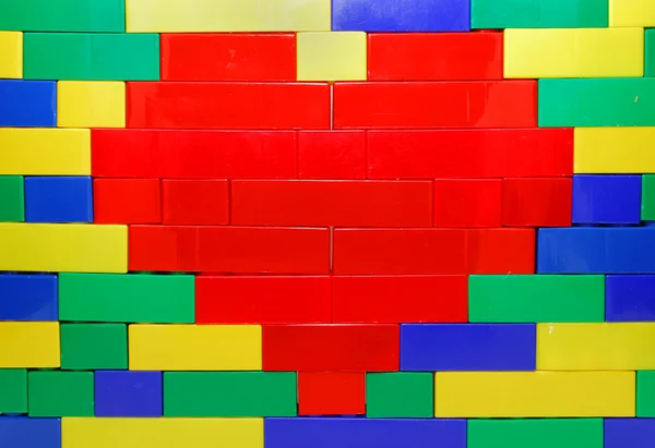 Lego-Herz an der Wand Stockbild