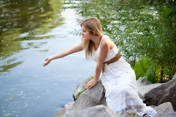 stock image Young cute girl near the river