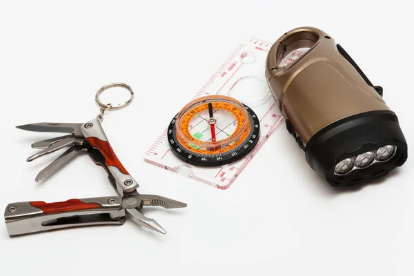 Knife, compass and an electric torch — Stock Photo, Image