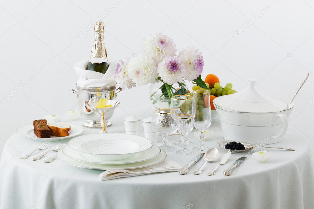 Table with dishes and flowers