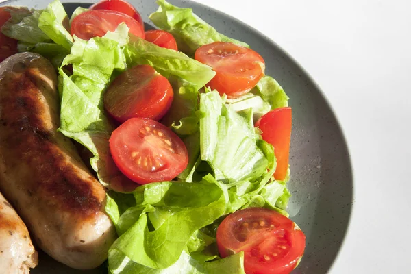 Stock image Sausages and salad with cherry tomatoes