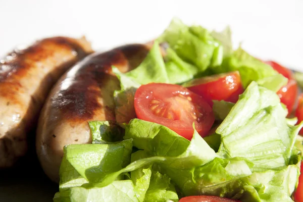 stock image Sausages and salad with cherry tomatoes