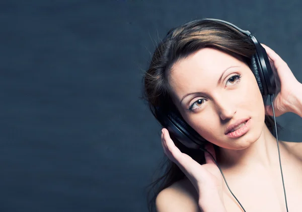 Женщина с наушниками слушает музыку — стоковое фото