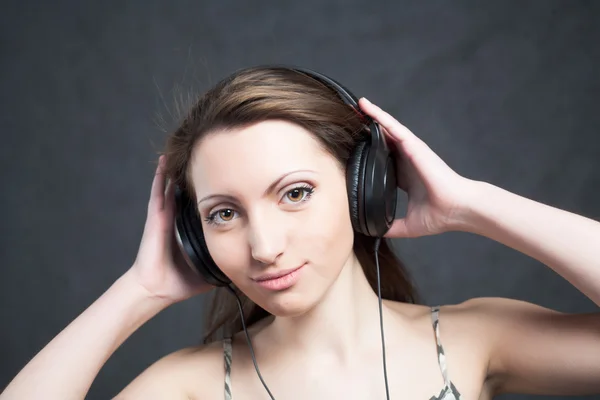Woman with headphones listening to music Stock Picture