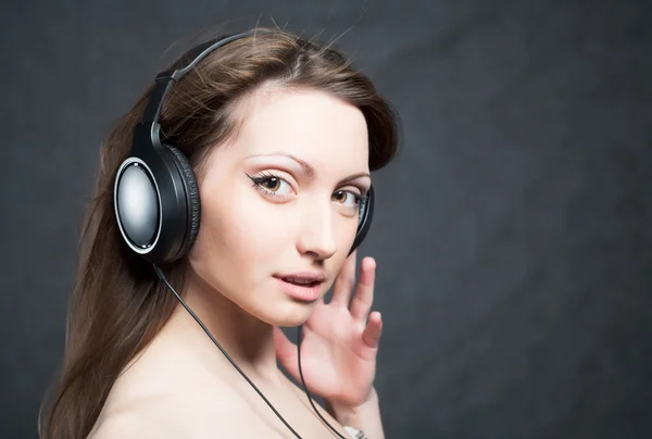 Woman with headphones listening to music Royalty Free Stock Images