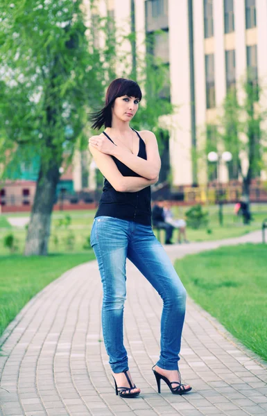 Chica está posando contra el parque — Foto de Stock
