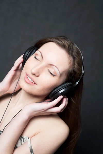 Žena se sluchátky poslech hudby — Stock fotografie