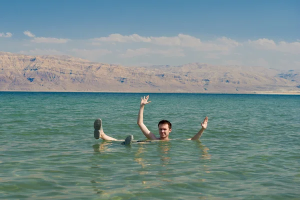 Mann treibt im Wasser des toten Meeres — Stockfoto