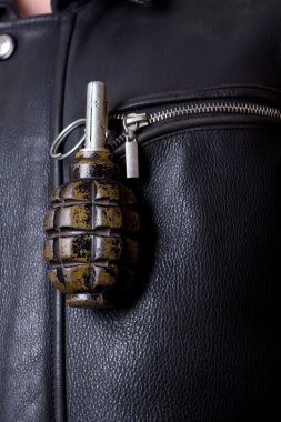 Hand grenade in leathers jacket`s pocket. clipart