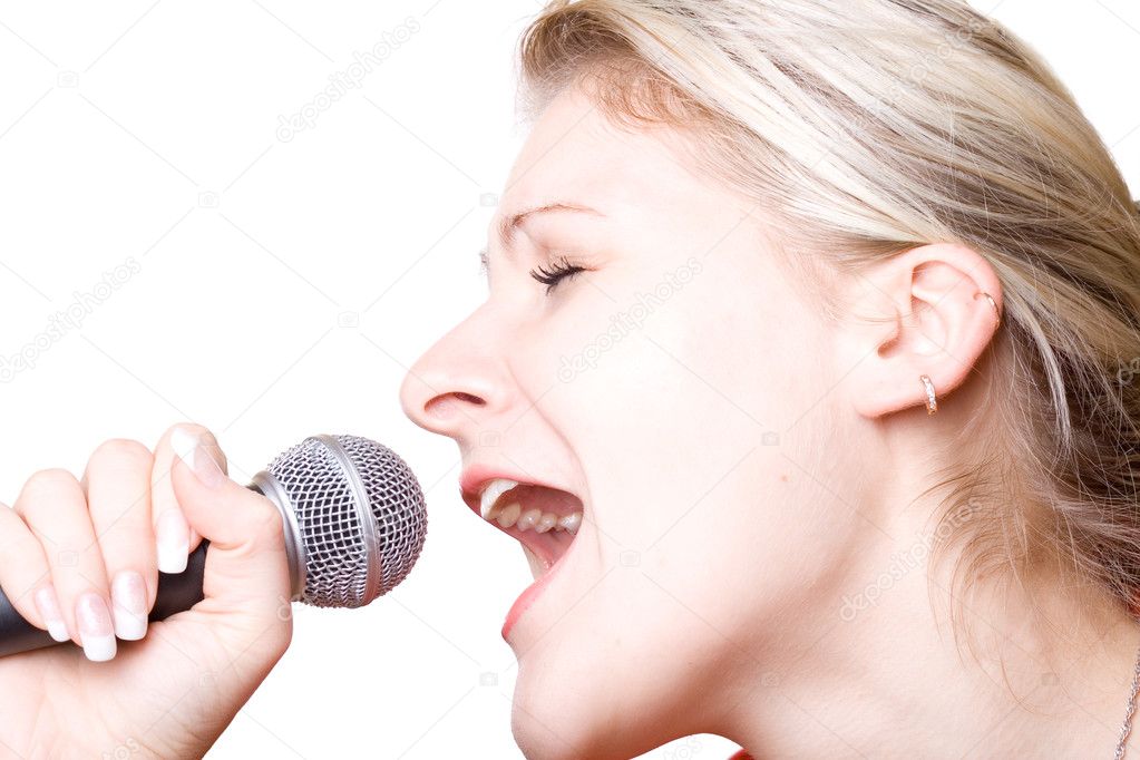 Girl sing with microphone. Isolated on white.