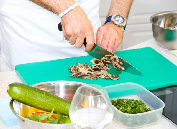 Chef cutting the mushrooms on a board — Stock Photo, Image