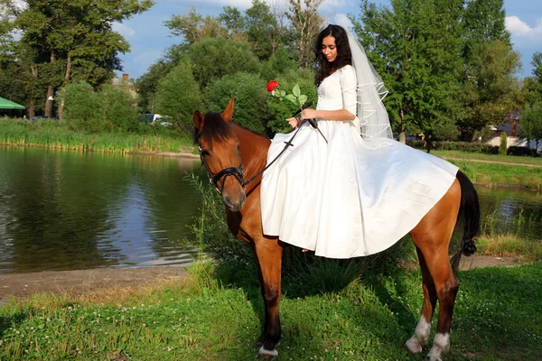 Bride horseback at horse — Stock Photo, Image