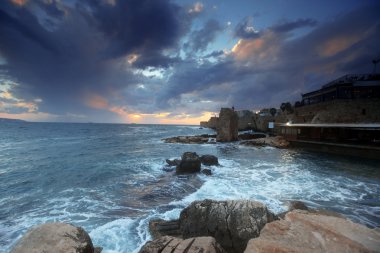 Sundown in the mediterranean at city of Acre in Western Galilee clipart