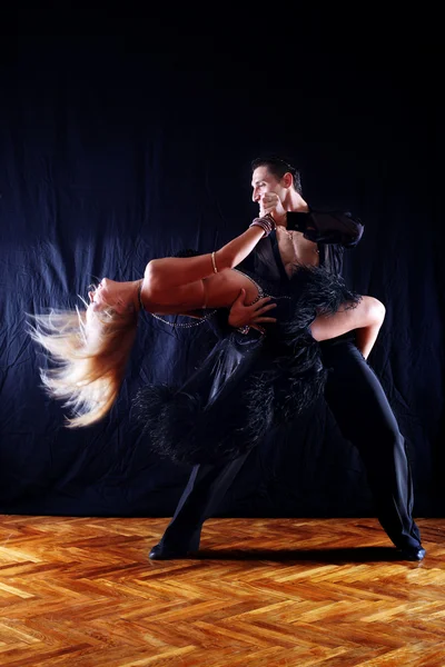 Danseurs dans la salle de bal sur fond noir — Photo