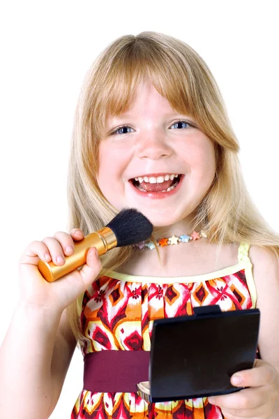 Menina pequena com escova de rosto e espelho isolado no branco — Fotografia de Stock