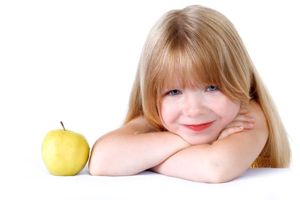 Little girl with yellow apple isolated on white — Stock Photo, Image