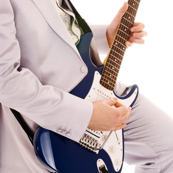 Man in white suit playing guitar — Stock Photo, Image
