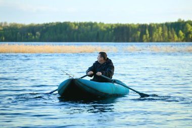 Fisherman in Rubber Boat clipart