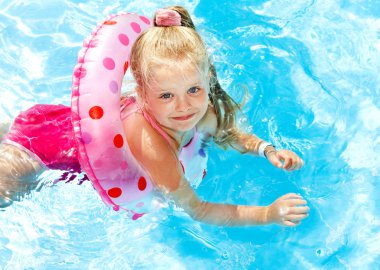 Child playing in swimming pool. clipart