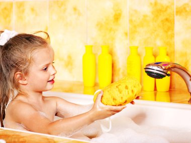 Kid washing in bath. clipart