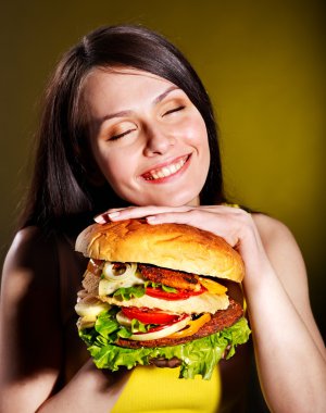 Woman holding hamburger. clipart