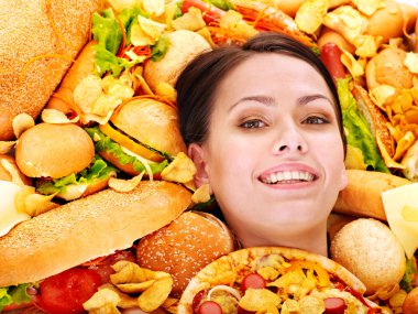 Woman eating hot dog. clipart