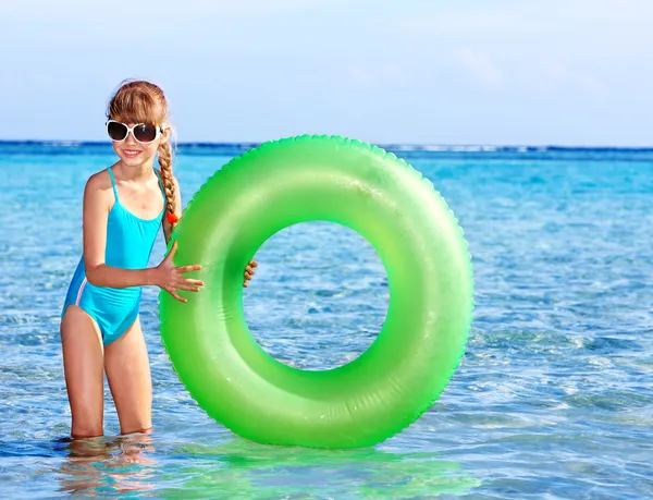 Children holding inflatable ring in sea. — Stock Photo, Image
