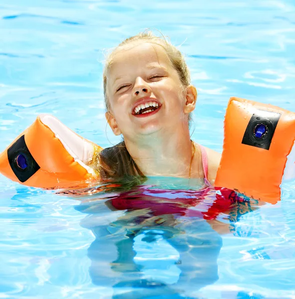 Niño con brazaletes en piscina — Foto de Stock