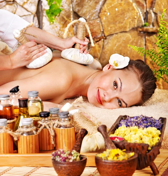 Woman getting thai herbal compress massage . — Stock Photo, Image