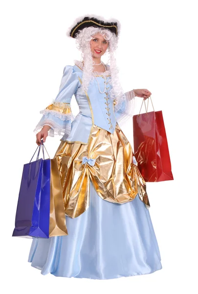 Vrouw in oude jurk met shopping tassen — Stockfoto