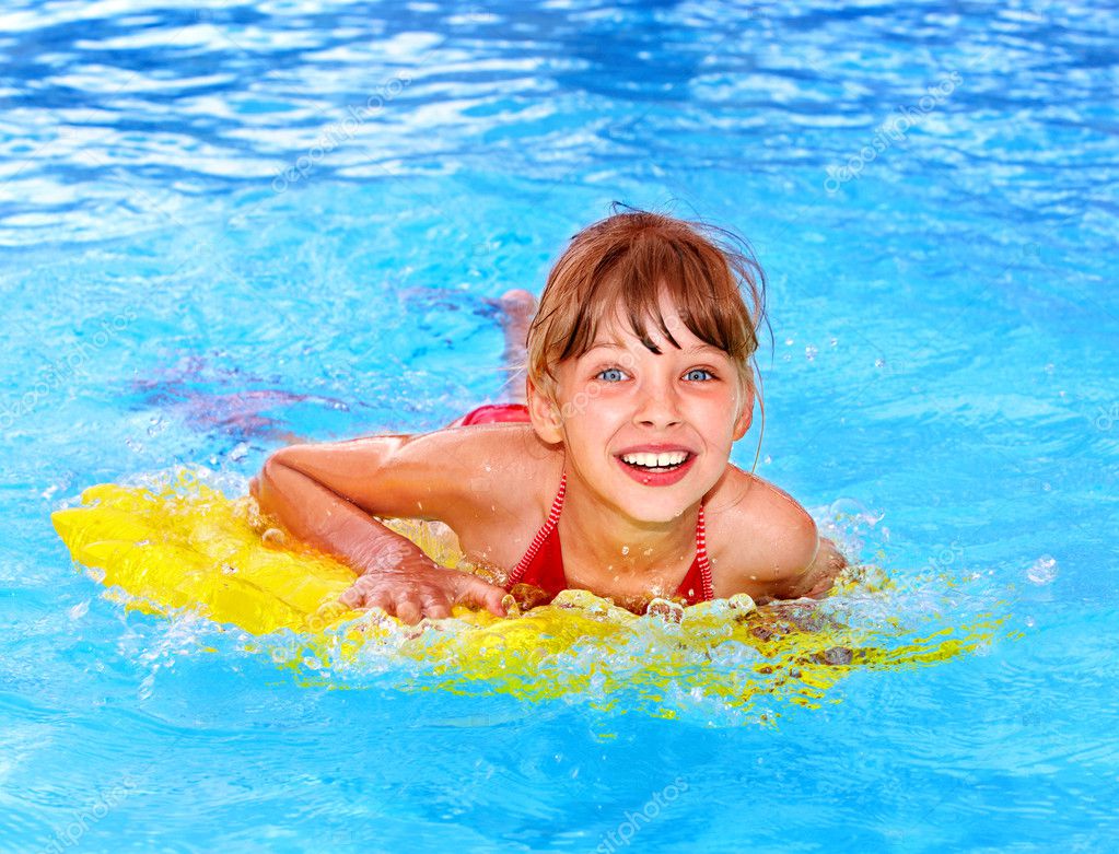 Child swimming on inflatable beach mattress. — Stock Photo © poznyakov ...