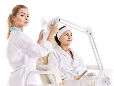 Woman on massage table in beauty spa. clipart