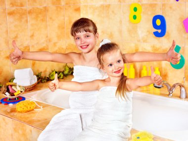 Kid washing in bath. clipart