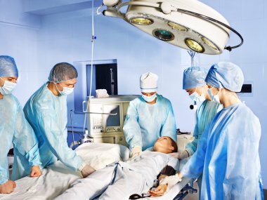 Group of surgeon in operating room. clipart