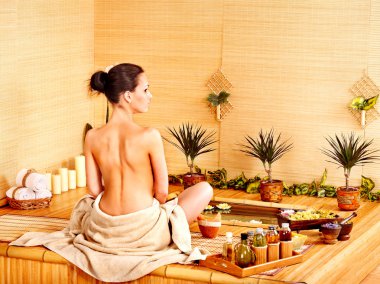 Bamboo massage at spa . clipart