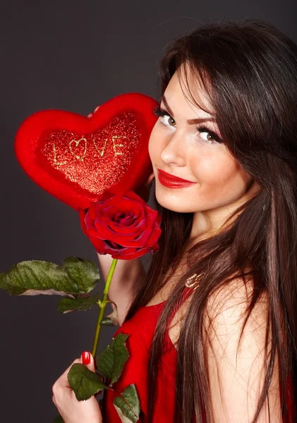 Girl holding heart and flower. — Stock Photo, Image