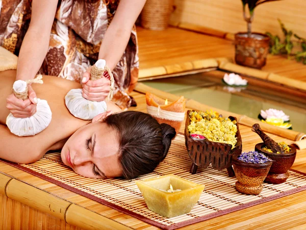 Woman getting massage in bamboo spa. Royalty Free Stock Photos
