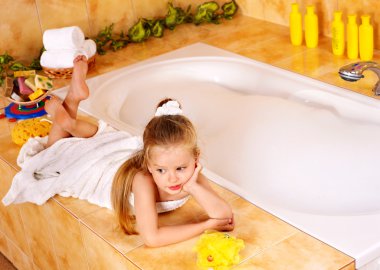 Kid washing in bath. clipart